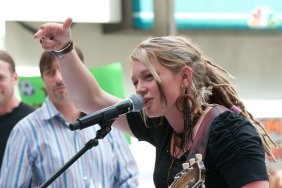 Crystal Bowersox black top, dreadlocks, bracelets, wooden hoop earrings, guitar